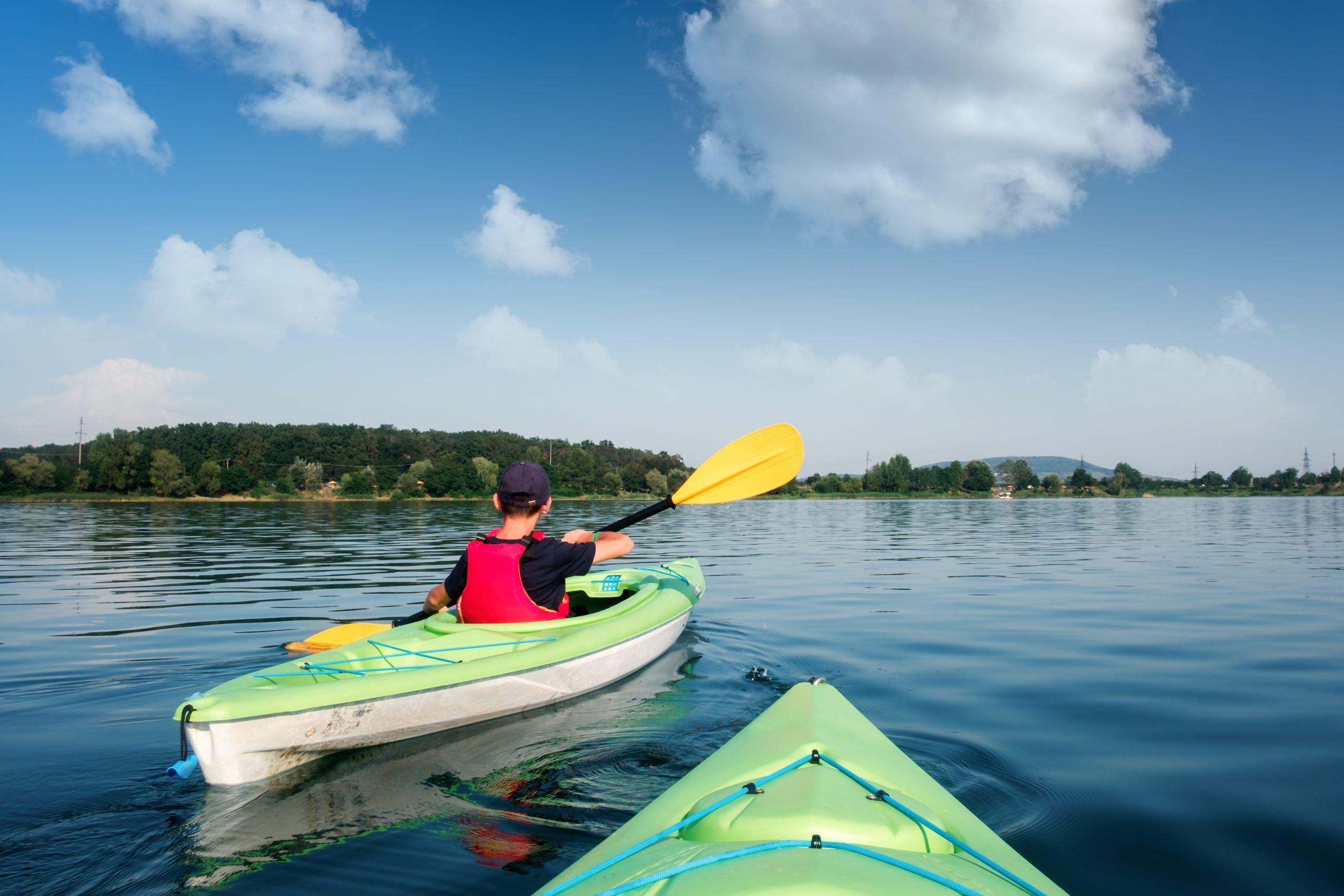 Boy,In,Life,Jacket,On,Green,Kayak.,Sunny,Day,On